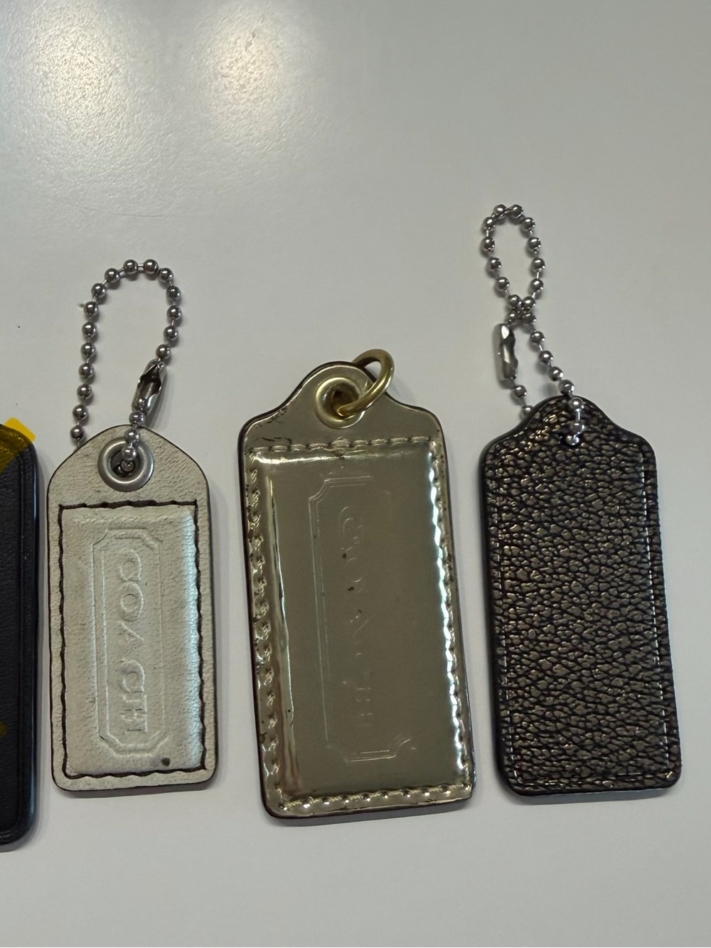 Coach Three-Piece Tag Set in white, Gold, pebbled gold & black